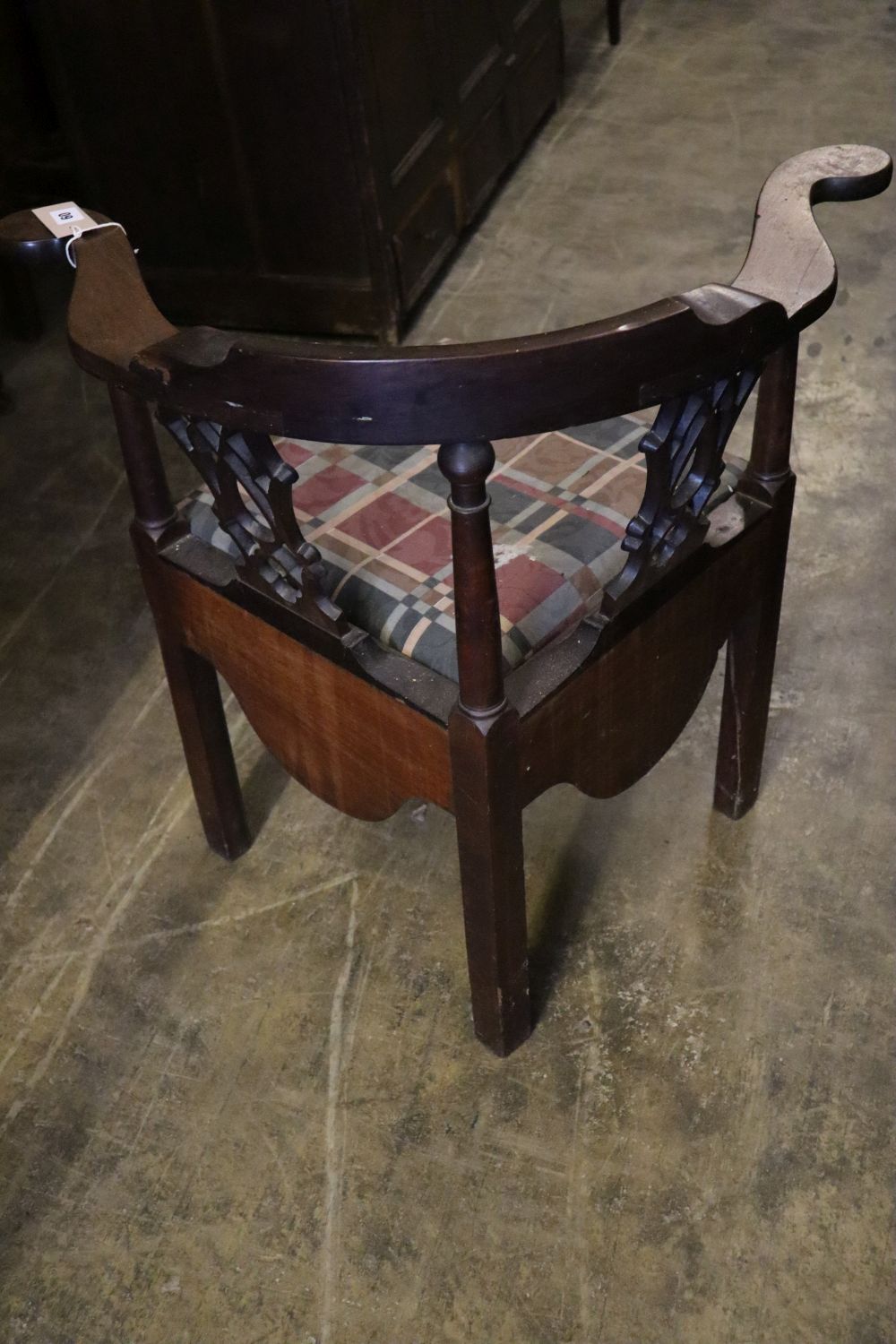 A George III mahogany corner elbow commode chair